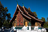 Wat Xieng Thong temple in Luang Prabang, Laos.  A view of the 'sim' with the large sweeping roof. 